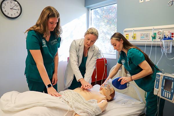 Jacksonville University professor teaching CPR to nursing students