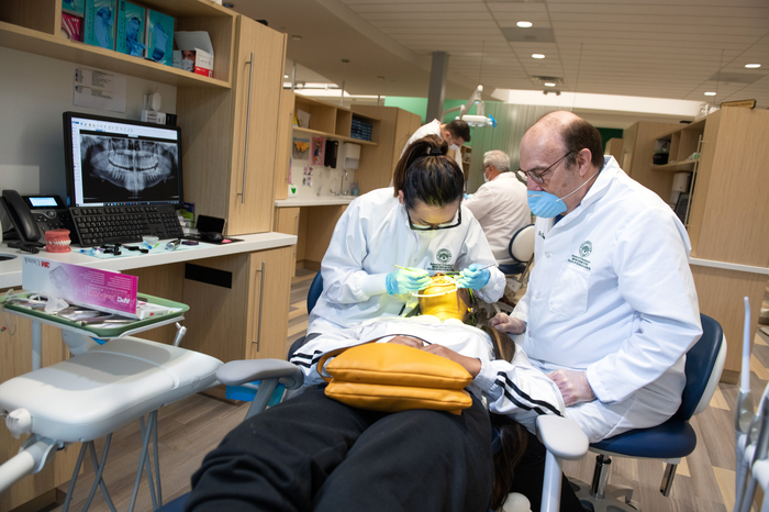 Orthodontic student practicing on a patient under supervision.